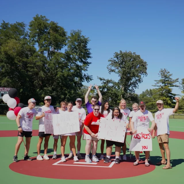 The @dreamon3unl Collegiate Dream Team welcomed Mikayla as their 2024-2025 Dreamer this past weekend and we couldn’t be more excited! The CDT surprised Mikayla with a cookout and their 2023-2024 Dreamer, Emma, was able to join in the fun. ❤️

Mikayla is a goal-oriented 21-year-old who loves to cheer on @huskerfootball! 🏈 She is an athlete and lover of all sports who has continued to face obstacles that test her mental and physical strength. Mikayla didn’t say her first word until she was six-years-old, which was followed by an autism and apraxia diagnosis. With her diagnoses, she has limited memory retention and a fear of the unknown, making it difficult for Mikayla to relate to her peers.

Despite her diagnoses, Mikayla loves sports and wants to try every single one that she can! That love of sports has helped her overcome and push through the obstacles in her life, reminding her that she is capable of anything she sets her mind to.

Mikayla is now attending University of Nebraska – Lincoln through the Trailblazers program, where she is working towards getting her Associates Degree in Coaching.

Mikayla’s dream is to attend a Nebraska football game as a VIP Husker and cheer on the athletes she admires, and we can’t wait to see @dreamon3unl make that Dream come true!

🎉 Help us welcome Mikayla to the Dream On 3 family!